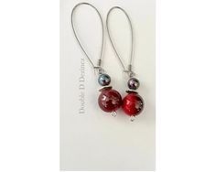 These handmade beaded earrings will make you look and feel stylish every time you put them on. Made with both red and silver-gray iridescent beads, these colorful dangle earrings can be worn all four seasons as well as on holidays. They will bring new life to your tired denim, and polish off a more sophisticated outfit with ease. Lightweight, these beaded earrings swing freely from long, nickel-free ear hooks with every move of your head. They look lovely with both long and short hair and they f Long And Short Hair, Cheap Costumes, Handmade Beaded Earrings, Handmade Earrings Beaded, Earrings Long, Ankle Bracelets, Minimalist Earrings, Long Earrings, Last Minute Gifts