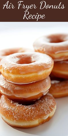 a pile of glazed donuts sitting on top of a white plate with the words air fryer donuts recipe