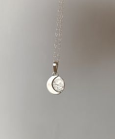 This sterling silver pendant with a crescent moon is a unique, handmade piece. Each moon has its own special shape, so no two are alike. If you prefer a specific position for the moon, please let me know. Additionally, the silver chain is adjustable, allowing you to wear it at your preferred length between 40 and 45 cm. It's the perfect accessory to add a special touch to your unique style. We use the highest quality silver, ethically sourced from European mines, to make this pendant. Made in Barcelona ---If you have any questions, write to me and I will be happy to assist you.---" Sterling Silver Sun And Moon Round Necklace, Sterling Silver Round Necklace With Sun And Moon Design, White Gold Sterling Silver Sun And Moon Jewelry, Sterling Silver Sun And Moon Jewelry, Sterling Silver Jewelry With Sun And Moon Design, Silver Moon Necklace With Sun And Moon Design, Silver Moon Jewelry With Sun And Moon Design, Sterling Silver Sun And Moon Round Pendant Jewelry, Silver Half Moon Necklace With Sun And Moon Design