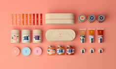 an assortment of beauty products on a pink background