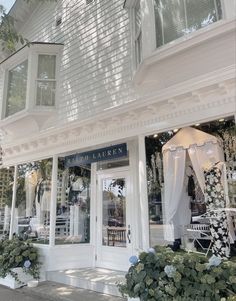 a store front with white curtains and windows