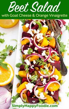 a salad with beets, oranges and feta cheese on a white plate