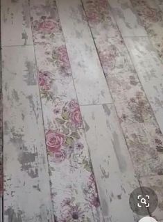 an old wooden floor with pink roses on it