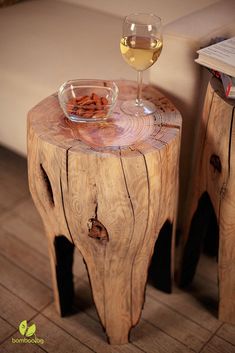 a glass of wine sitting on top of a wooden table