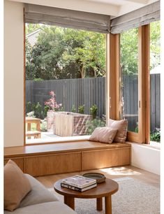 a living room filled with furniture next to a wooden window sill and sliding glass doors