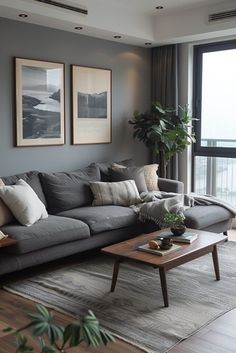 a living room filled with furniture and a large window overlooking the ocean in front of it