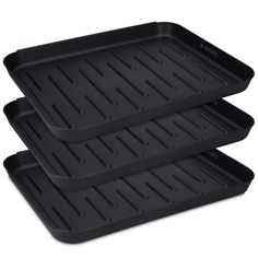 three black trays sitting on top of each other