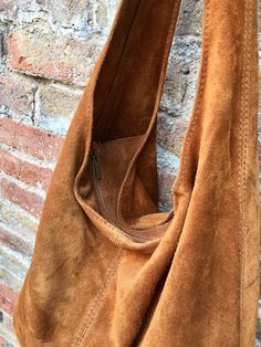 Slouch bag in soft brown suede. Soft leather shopper. LARGE tote leather bag in CAMEL BROWN with zipper. Natural genuine SUEDE leather. NOT LINED. Light tobacco color carry all bag. Width : 42cm - 16,5 in Height at the center: 34 cm - 13, 5 inc Total height : 65,5 cm - 26 inch This bag in different colors and other leather Bags by Good Times Barcelona: https://www.etsy.com/shop/goodtimesbarcelona?section_id=18820154&ref=shopsection_leftnav_10 Also available a matching camel brown suede bel a Camel Leather Bag With Zipper Closure, Suede Hobo Tote Bag With Soft Leather, Suede Tote Hobo Bag With Soft Leather, Suede Hobo Bag With Soft Leather, Brown Hobo Bag With Suede Lining For Shopping, Soft Leather Suede Hobo Tote Bag, Brown Suede Bag With Soft Leather, Soft Suede Brown Leather Bag, Camel Soft Leather Hobo Bag