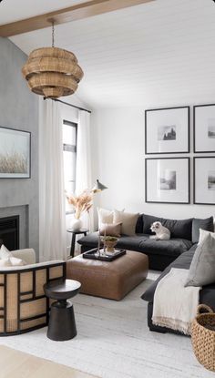 a living room filled with furniture and pictures on the wall