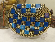 This bag is a statement piece of jewelry. Boho Clutch metal bag-purse that won't stop bringing you complements and turn heads around. Handmade from Brass and inlaid with mosaic & healing stones, one by one, makes every purse one of a kind ethnic bohemian clutch purse, tribal style, vintage look evening bag. Made in the Himalayas, inside filled with velvet, to complete the ethnic but elegant look for each bag. You can hang it on your shoulder or use it as a clutch (by tucking the chain in the Blue Crossbody Clutch As Gift, Blue Crossbody Clutch For Gift, Artisan Blue Shoulder Bag As Gift, Artisan Rectangular Clutch As A Gift, Boho Clutch Bag, Mosaic Stones, Bohemian Clutch, Metal Mosaic, Beacon Ny