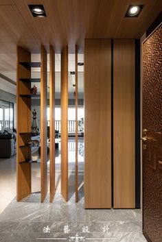 an open door leading to a living room with wood paneling on the walls and floor