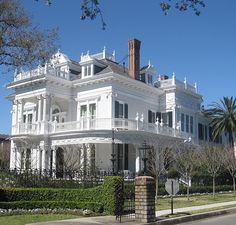 a large white house with many windows and balconies