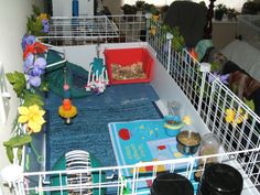 a caged area with various items and flowers on the floor in front of it