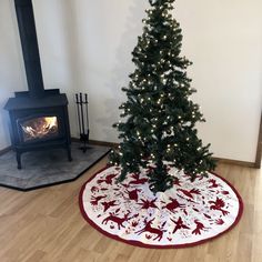 a small christmas tree in the corner of a room with a rug on the floor