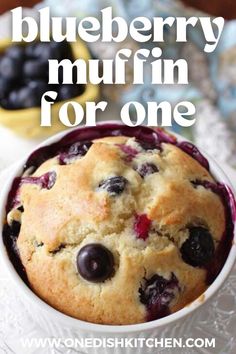 blueberry muffin in a white bowl with text overlay that reads, blueberry muffin for one