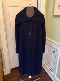 Kinda love the alpaca and mohair contribution to this lightly brushed coat! This coat is made of 40% wool, 22% alpaca, 20% polyamide and 18% mohair in a brushed purple.  The lining is 52% polyester and 48% rayon.  It does not have shoulder pads.  It features a large collar, long sleeves, inset pockets, and a flared body. This garment is clean, with no stains or moth holes. Measurements to guide you: Armpit to armpit: 26.5" Waist across: 25" Hips across: 27.5" Sleeve: 24" Length from top of shoulder to hem: 40.5" just below knee Please compare your own measurements with those provided above for assurance of fit. Remember to leave some room for heavy clothing on underneath. Decade: 90s Fabric: Wool/Alpaca/Polyamide/Mohair Size: XL-1X Condition: Great Brand: Talbots It's a delight to pick thr Heavy Clothing, Coat Dress, Shoulder Pads, Alpaca, Long Dress, Violet, Jackets For Women, Jackets & Coats, Bathing Beauties