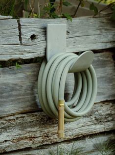 a garden hose attached to a wooden fence