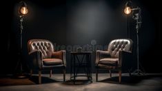 two leather chairs sitting next to each other in front of a lamp on a table