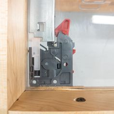 the inside of a cabinet door with some tools in it and a screwdriver