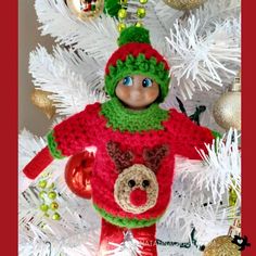 a crocheted christmas ornament with a teddy bear in a red sweater