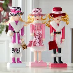 three toy figurines are standing next to each other