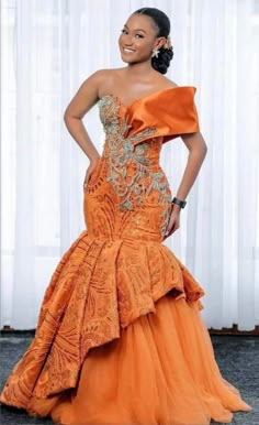 This beautiful Orange Lace Mermaid Prom Gown is perfect for any special occasion. This spectacular floor length dress is sure to make a statement and turn heads. The sleeveless design is flattering and comfortable, with a unique off shoulder neckline. This Nigerian fashion dress is perfect for any dinner or wedding. The lace bodice is form-fitting and accentuates your natural curves, while the long skirt gives you a stunning silhouette. This dress is sure to make you feel beautiful, confident and ready for any formal occasion. Note: Please note that the exact fabric might not be available as at when ordered. However, we will substitute it with an equally good fabric to make the dress, due to market changes. This gorgeous blue lace gown is sure to make you feel as beautiful as you look! Thi South African Traditional Dresses, African Bridal Dress, Dinner Gown, African Traditional Wedding Dress, African Wedding Attire, Shweshwe Dresses, African Bride, African Prom Dresses, Afrikaanse Mode