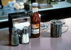 the kitchen counter is cluttered with spices and condiments, such as salt and pepper shakers