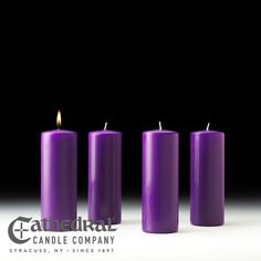 three purple candles sitting next to each other