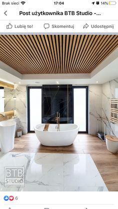 a large white bath tub sitting inside of a bathroom