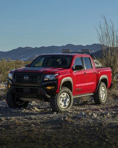 a red pick up truck parked in the desert