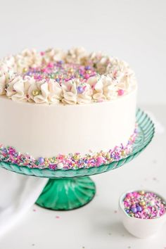 a cake with sprinkles and white frosting