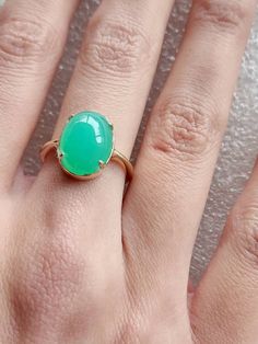 Chrysoprase ring in 10 carat yellow gold, quality green Chrysoprase ring, oval cabochon Chrysoprase ring The Chrysoprase measures 14x10mms and weighs 5.4 carats The ring is in 10 carat yellow gold Ring size is M (Australian size) or 7 1/4 (US size). Ring is ready to ship in 1-2 working days.  We resize free of charge.  Please allow a couple of additional days for resizing. All my rings come in a velvet ring box.  I am highly conscious of environmental damage that extra packaging can create so my Classic Green Oval Opal Ring, Oval Cabochon Emerald Ring For May Birthstone, Green Oval Opal Ring, Classic Green Cabochon Emerald Ring, Green Emerald Oval Cabochon Ring, Green Emerald Ring With Oval Cabochon, Classic Green Emerald Oval Cabochon Ring, Classic Green Oval Cabochon Emerald Ring, Yellow Gold Emerald Chrysoprase Cabochon Ring