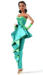 a barbie doll wearing a green dress and high heeled shoes with her hands on her hips