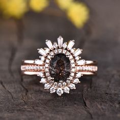 a brown diamond ring sitting on top of a piece of wood next to yellow flowers