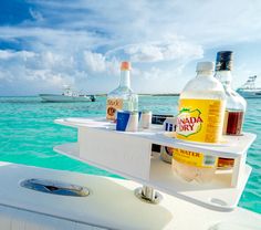 bottles and drinks are sitting on the back of a boat