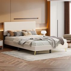 a bedroom with a large bed and wooden flooring in front of a wall mounted cabinet