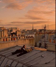 two people sitting on the roof of a building