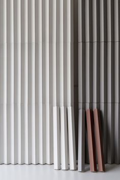 the wall is lined with vertical striped panels