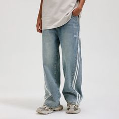 The Washed Striped Wide-Leg Pants seamlessly blend vintage style with contemporary craftsmanship. Featuring an all-over washed and distressed look, these pants are adorned with embroidered logos on each hip. The striking contrast stripes run from the back waist down the front of the legs, enhancing the body’s natural silhouette. Functional front pockets are decorated with rivets, while two back pockets provide additional utility. Crafted from premium fabric, these slightly oversized pants offer Oversized Pants, Striped Wide Leg Pants, Brand Sale, Accessories Branding, Rivets, Sale Design, Male Model, Oversized Fits, Leg Pants