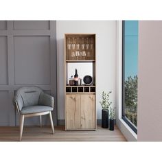 an empty chair sitting next to a wooden cabinet filled with wine glasses