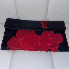 Giorgio Armani Vintage Leather Clutch W/ Red Flower Beads. Pre-Loved. Butter Soft Black Leather. Magnetic Closure. Small Pocket Inside; No Closure. Dime-Size Water Stain On Outside Flap; Blue/Green In Color. Beading & Stitching Are Not Intact. Small Stain On Inside Of Flap/ Red In Color. Stains On Outside Of Inside Pocket. Minimal Scratches. Authentic. Not Cleaned. Used. Buying Vintage Items Please Keep In Mind That Pieces Marked As Vintage Are Not In A New Condition, They Are Pre-Worn And Will Often Show Slight Signs Of Wear Or Normal Aging Red Embellished Evening Bag, Red Embellished Clutch For Formal Occasions, Elegant Red Embellished Evening Bag, Elegant Red Leather Clutch, Red Embroidered Clutch For Evening, Red Beaded Clutch For Party, Elegant Embellished Red Bags, Elegant Red Embellished Bag, Elegant Red Beaded Bag