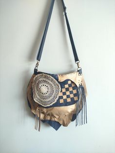 This bohemian bag is made of upcycled genuine  leather navy and beige colors.  Closure is zipper. There are 1 zippered pocket inside and lined with duck canvas fabric.  There is one  pocket on the back. Also a secret small pocket on thr front.  Its  inner width is 30 and height is 29 cm. Thickness is 5 cm. (11.8'' x11.4'' x 2'' ) Strap is adjustable. Please note that color may vary according to monitor color calibrations. If you have any question, please don't hesitate me to ask whatever you want know. Beige Leather Bohemian Hobo Bag, Beige Bohemian Leather Hobo Bag, Bohemian Beige Leather Hobo Bag, Bohemian Hand-stitched Crossbody Bag, Bohemian Hand-stitched Crossbody Satchel, Handmade Crossbody Hobo Bag For Festivals, Bohemian Upcycled Tote Shoulder Bag, Everyday Leather Crochet Crossbody Bag, Bohemian Upcycled Bags For Daily Use