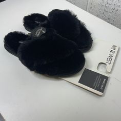 Stay Cozy And Stylish With These Nine West Black Fuzzy Slippers, Perfect For Lounging At Home. Designed For Women, These Small-Sized Slippers Offer Comfort And Warmth. Black Fuzzy Design Small Size Comfortable Fit Durable Material Perfect For Home Use Features: Casual Size: Womens S Condition: New With Tags Never Worn Cozy Black Slip-on Slippers, Black Cozy Slippers With Round Toe, Black Slip-on Winter Slippers, Black Winter Slippers With Round Toe, Black Flat Slippers For Winter, Black Flat Winter Slippers, Comfortable Black Slippers For Streetwear, Black Round Toe Slippers For Fall, Comfortable Black Slippers For Fall