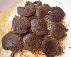 a white plate topped with chocolate desserts covered in powdered sugar