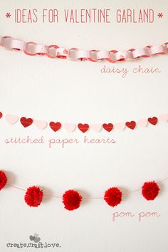 valentine's day garland with pom - poms and paper hearts on it