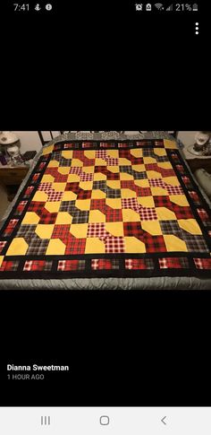 a quilt is displayed on a table top