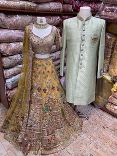 Mens Sherwani: sage green brocade sherwani with embroidered buttons and with a broach. Womens Lehenga: Lemonade Yellow manifesting beautiful jaal of flowers, temple and figurines motifs enriched with intricate embroidery of sequins, thread, pearl, cutdana & stone work enchants royalness. Teamed with similarly embroidered blouse and net dupatta with embroidered borders. Embroidered Buttons, Mens Sherwani, Green Lehenga, Royal Green, Matching Outfit, Indian Bridal Outfits, Tomboy Style Outfits, Net Dupatta, Stone Work