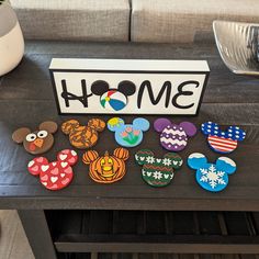 mickey mouse cookies are sitting on a table next to a sign that says homer and other disney characters