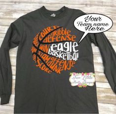 a black long sleeve shirt with an orange and white basketball ball on it, saying your team name here