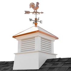 a weathervane on top of a roof with two roosters perched on it